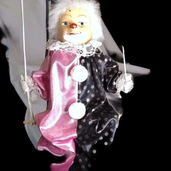 porcelain clown doll on swing